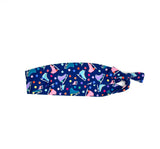 Navy blue headband with colorful ice skate pattern on a white background