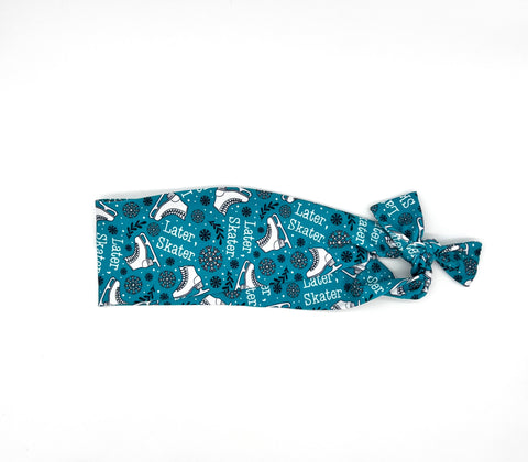 Blue hair tie with 'Later Skater' text and skate designs on a white background