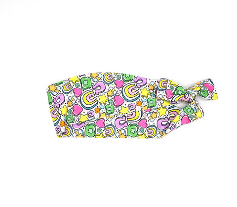 Colorful hair tie with Lucky Charms and Rainbow pattern on a white background