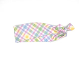 Pastel checkered hair tie on a white background
